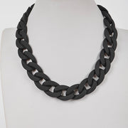 Chunky matte black link chain necklace on a mannequin bust.